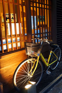 Bicycle parked against window
