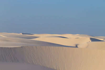 Scenic view of desert against clear blue sky