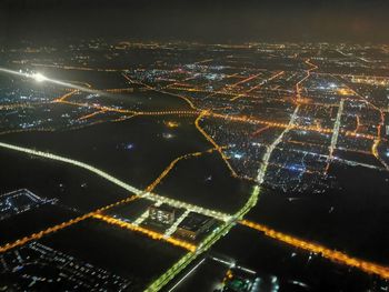 Aerial view of illuminated city at night