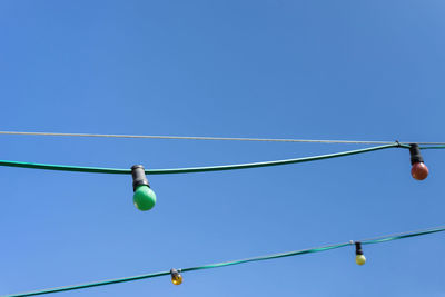 Low angle view of cable against clear blue sky