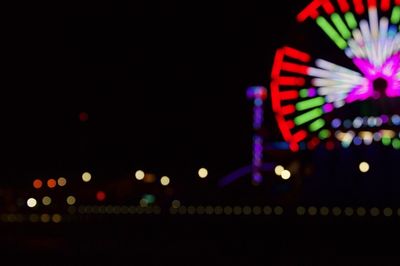 Illuminated ferris wheel at night