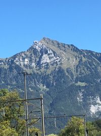 Scenic view of mountains against clear blue sky