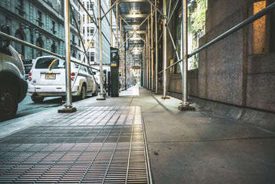 Footpath amidst buildings in city