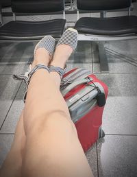 Low section of woman sitting in car