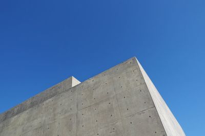 Low angle view of building against clear blue sky