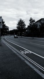 Cars on road against sky