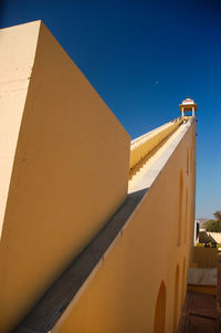 Low angle view of building against clear blue sky