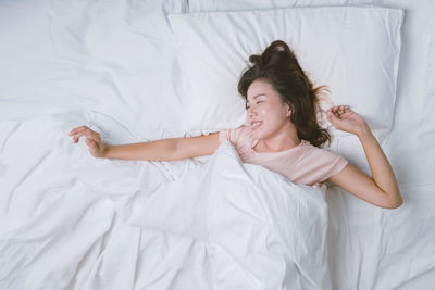 Directly above shot of young woman lying on bed