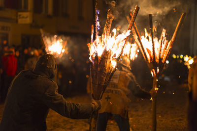 Chienbaese festival. switzerland, liestal, feb 18. participants carrying burning logs