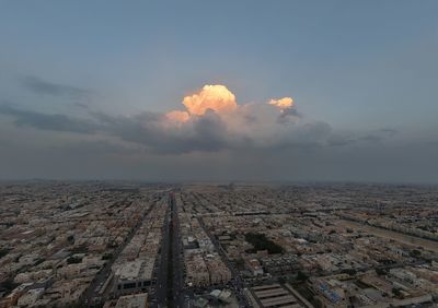 Aerial view of cityscape against sky during sunset