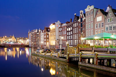 Canal passing through city at night