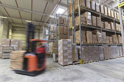 Moving forklift in factory hall