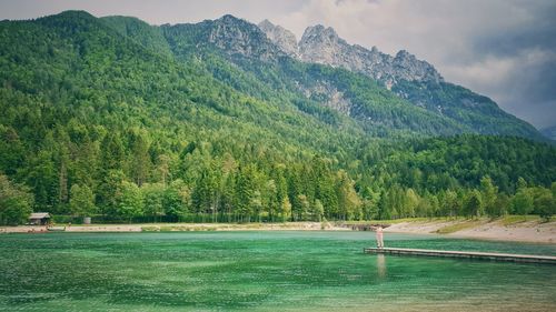 Scenic view of lake and mountains against sky