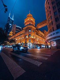 Illuminated city street and buildings at night