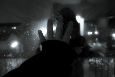 Silhouette of woman in dark room