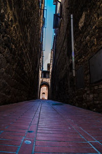 Surface level of narrow alley along buildings