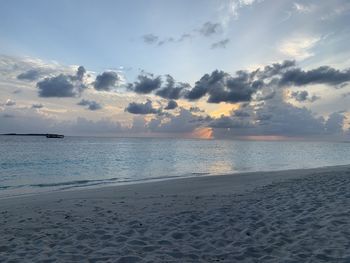 Scenic view of beach against sky during sunset