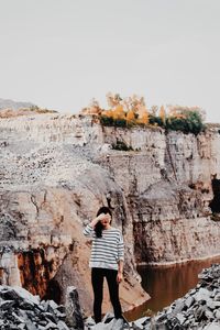 Full length of woman standing on rock