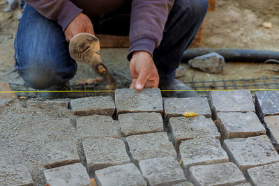 Rear view of man working on stone