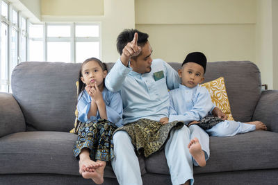 Father and son on sofa