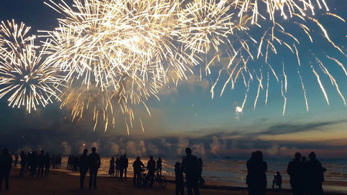 Low angle view of silhouette people against sky at night