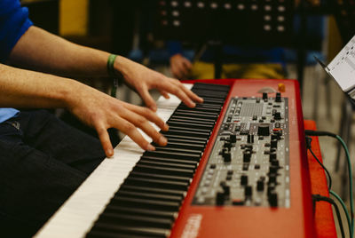 Midsection of man playing piano