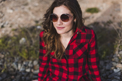 Portrait of smiling young woman wearing sunglasses