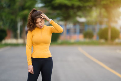 Young woman exercising on road