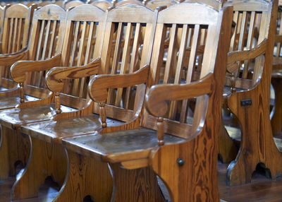 Empty chairs and tables in row