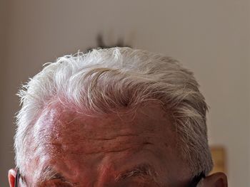 Close-up of senior man with white hair at home