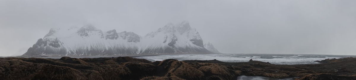 Panoramic view of mountains against sky during winter