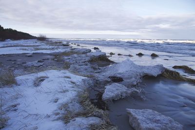 Rocks on beach against sky