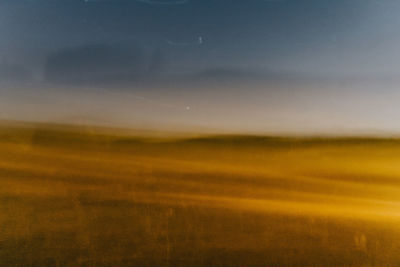 Scenic view of field against sky during sunset