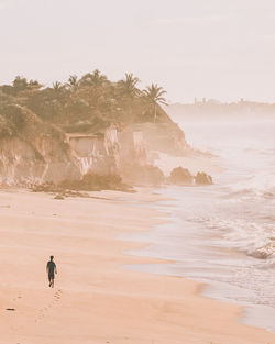 Man on beach against sky