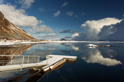 View of pier in lake against sky