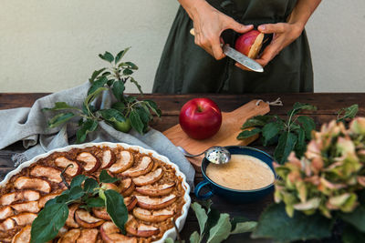 Cropped hand of woman preparing food on table