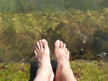 Low section of man legs in water