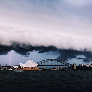 View of bridge over river against cloudy sky