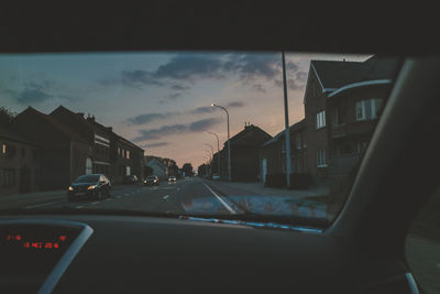 Cars on street seen through windshield