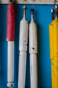 Close-up of pipes against blue wall