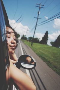 Woman with eyes closed traveling in car