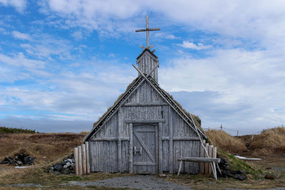 House on field against sky