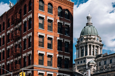 Low angle view of buildings in city against sky