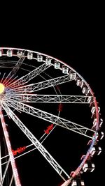 Low angle view of illuminated ferris wheel against sky at night