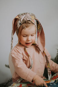 Toddler baby girl in funny hat with ears having fun