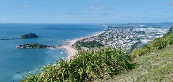 High angle view of sea and city against sky