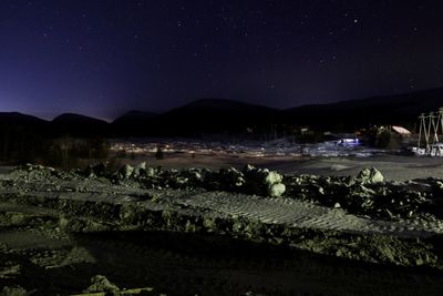 Scenic view of lake against clear sky at night