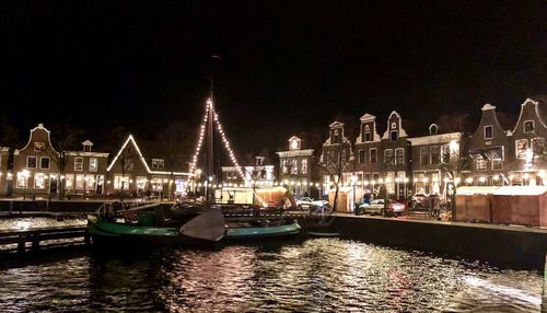 Boats in river at night
