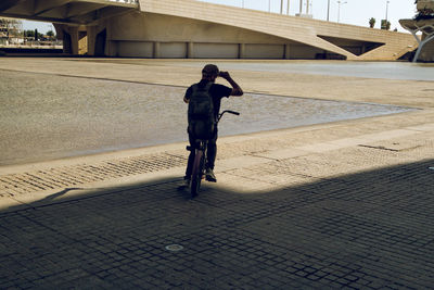 Man performing stunt on bicycle in city 