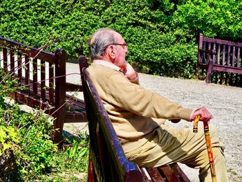 Man sitting on bench in park